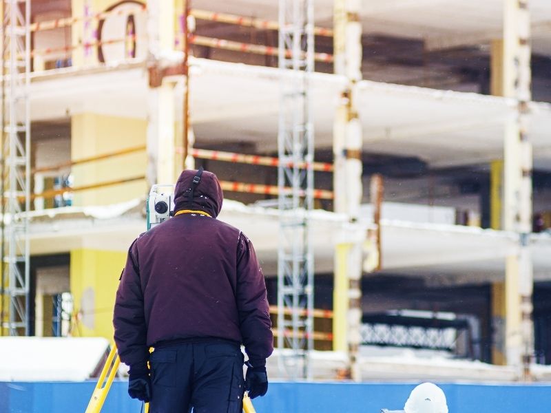 Commercial property surveyor construction site - Madison Land Surveying Commercial property surveyor working near a multi-story construction project